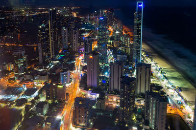 High angle view of illuminated city buildings at night