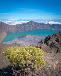 Scenic view of mountains against blue sky