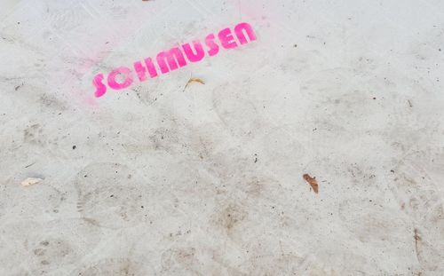 High angle view of text written on the beach