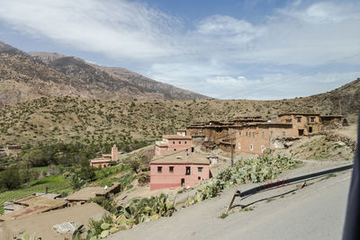 Panoramic view of buildings and mountains against sky