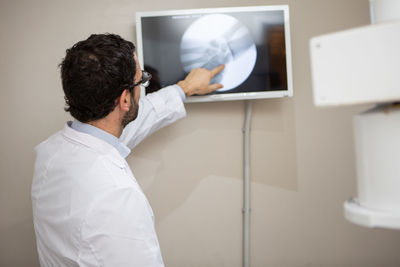 Side view of young man working in office