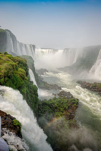 Scenic view of waterfall against sky