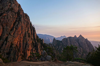 Scenic view of rocky mountains against sky during sunset