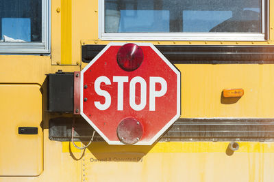 Close-up of stop sign on bus