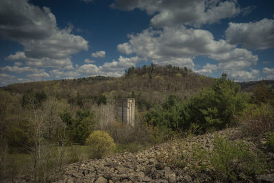 Abandoned building on field against sky