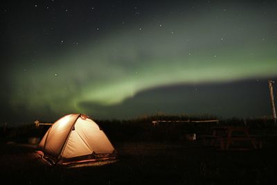 Tent on field against sky at night