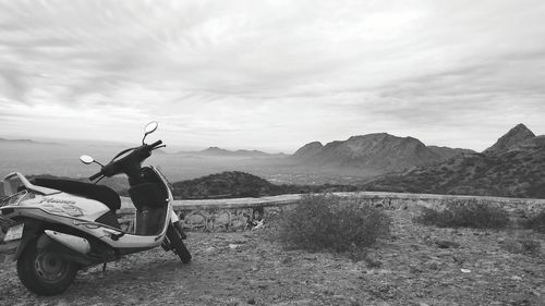 Man on motorcycle against mountain range