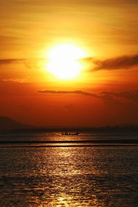 Scenic view of sea against romantic sky at sunset