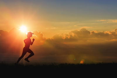 Full length silhouette woman running on field