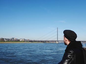 Rear view of man on bridge against sky