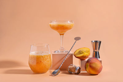 Wineglass on table against orange background