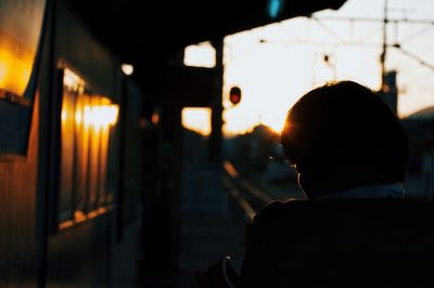 Rear view of woman standing at night