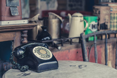 Close-up of old telephone booth on table