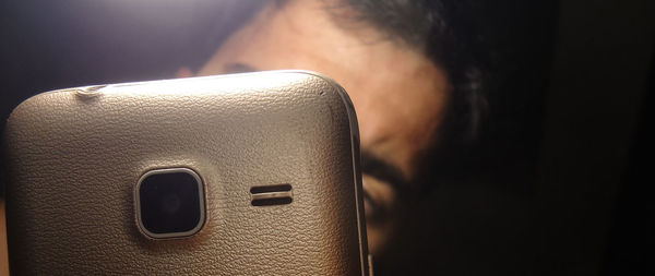 Close-up of man using mobile phone