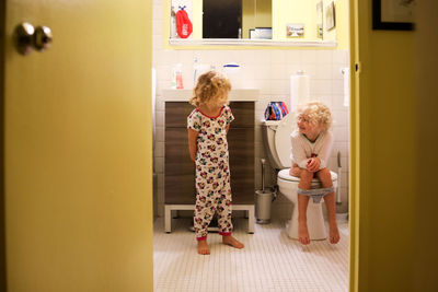 Sisters talking bathroom early morning