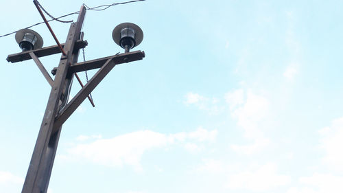 Low angle view of telephone pole against sky