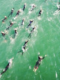 High angle view of people swimming in sea