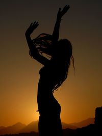 Silhouette of woman at sunset