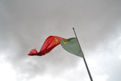 Low angle view of portuguese flag against sky