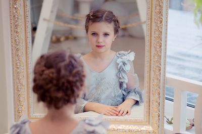 Cute girl reflecting in mirror