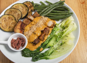 Crispy kare kare, pork belly are sauce with peanuts and vegetables, filipino cuisine.