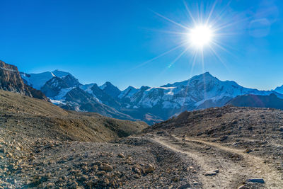 Scenic view of mountains against blue sky