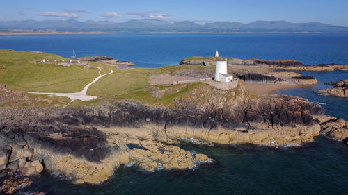 Scenic view of sea and lighthouse buildings against sky