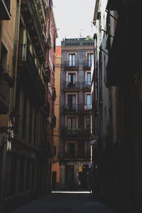 Narrow street amidst buildings against sky