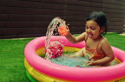 Girl playing in wading pool