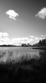 Scenic view of field against cloudy sky