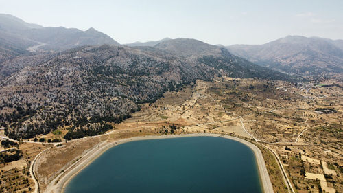 Aerial view of land and mountains against sky