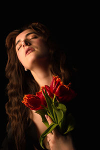 Portrait of young woman with roses