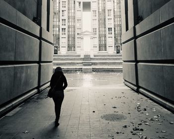 Full length rear view of man walking on street