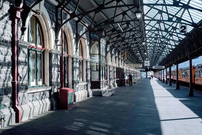 People walking on railroad station platform in city