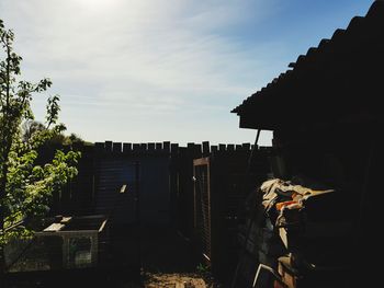 Plants and buildings against sky