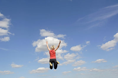 Low angle view of a woman jumping