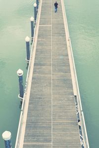 High angle view of people on pier by sea