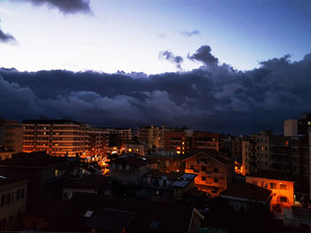 Illuminated cityscape against sky