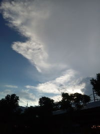 Low angle view of silhouette trees against sky