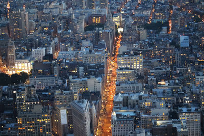 High angle view of city lit up at night