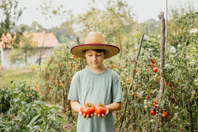 Full length portrait of man wearing hat against plants