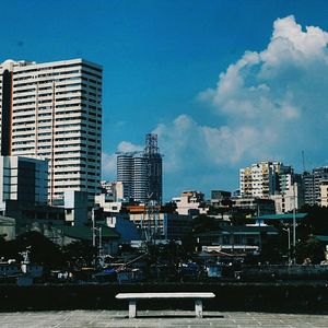 Buildings in city against blue sky