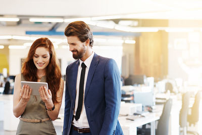 Business people looking at digital tablet in office