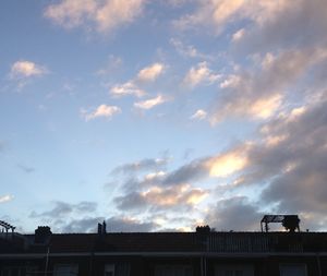 Low angle view of building against cloudy sky