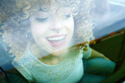 Cheerful woman sitting in car