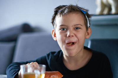 Portrait of boy with ice cream at home