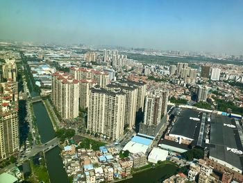 High angle view of modern buildings in city against sky