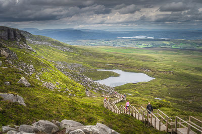 High angle view of people on mountain against sky