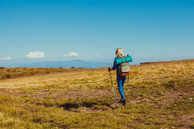 Full length of man standing on field against sky