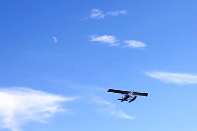 Low angle view of airplane flying in sky